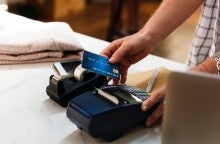 Credit card being run through a card reader.