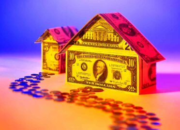 multicolored house made of money with path of penny to illustrate second chance loans
