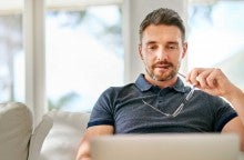 Man at laptop computer contemplating how the new tax laws affect him