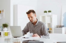 Man at computer reading how to file taxes for free