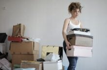 A woman moves her boxes.