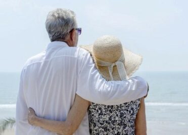 couple on beach thinking about buying a vacation home