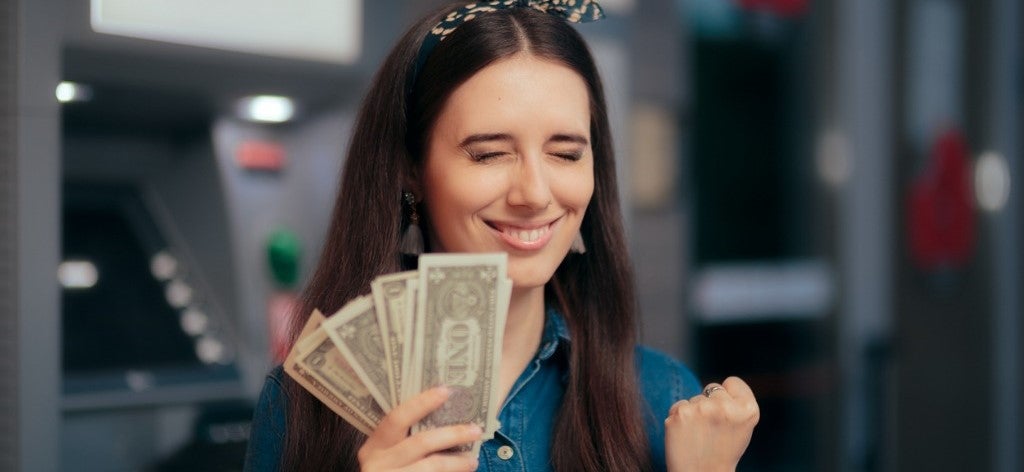 woman with money in hand excited to find unclaimed money