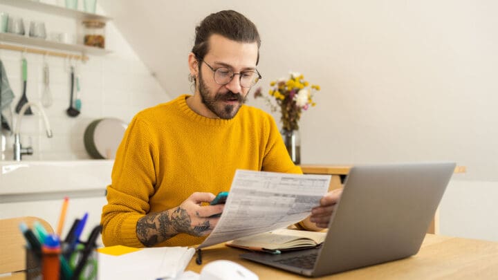 Man checking files with laptop open