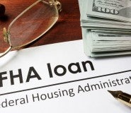 Picture of FHA loan application with glasses and stack of money