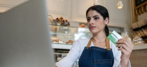 woman owner of bakery learning how do credit cards work